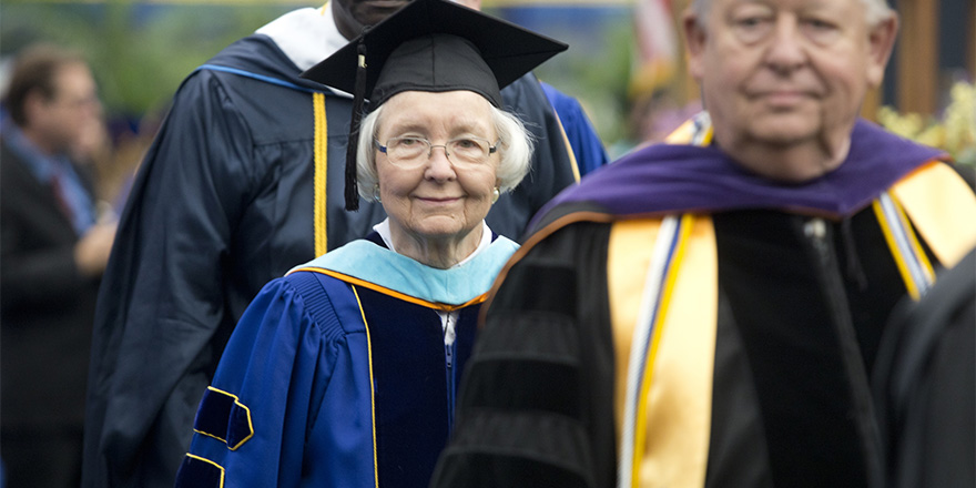 mature woman standing in line to get her diploma